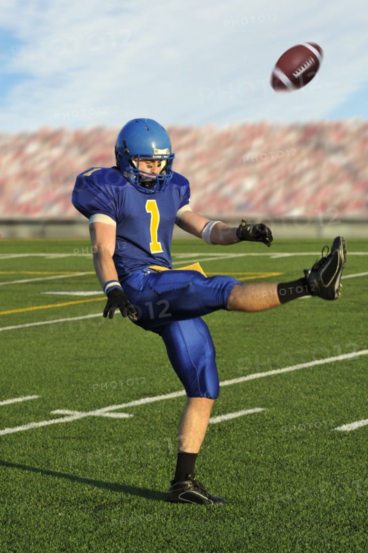 Caucasian football player kicking football