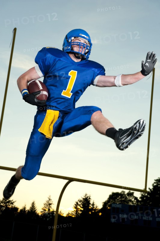 Caucasian football player running with football