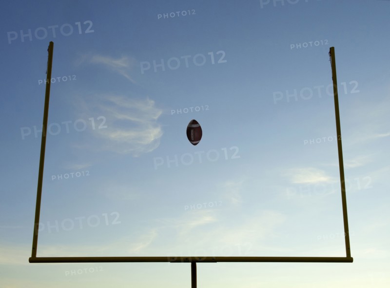 Football being thrown through goal posts