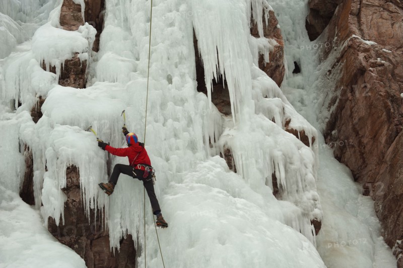 Caucasian man climbing ice
