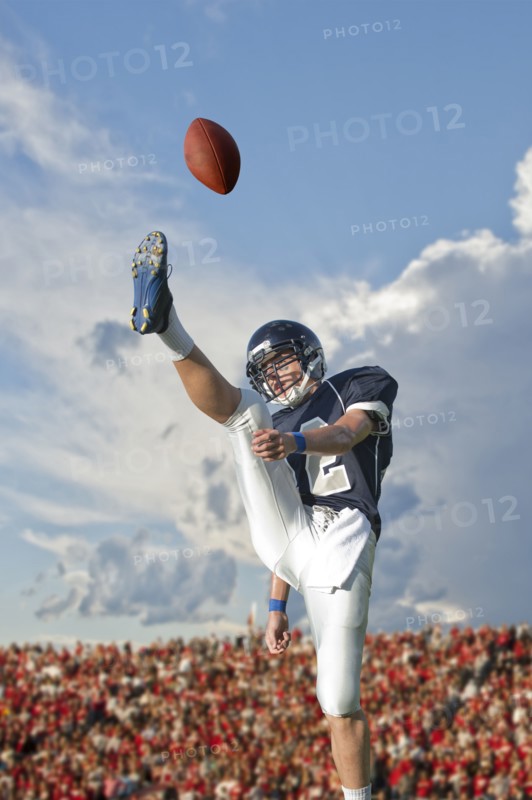 Caucasian football player kicking ball