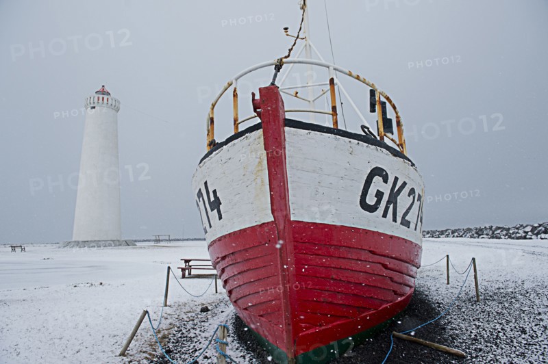 Ship docked near lighthouse