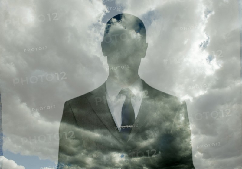 Double exposure of businessman in clouds
