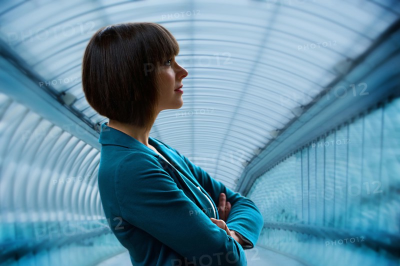 Caucasian businesswoman standing in tunnel