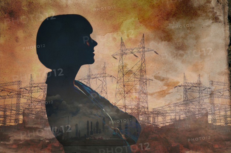 Double exposure of businesswoman and power lines