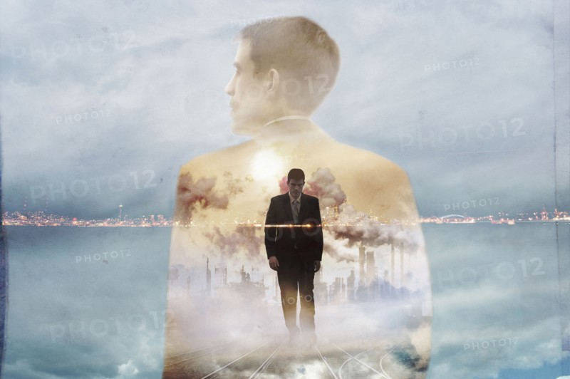 Double exposure of businessman and urban coastline