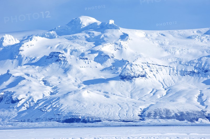 Iceberg looming over arctic landscape
