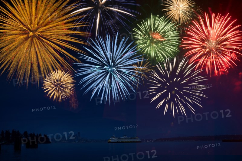 Fireworks exploding over cruise ship in bay