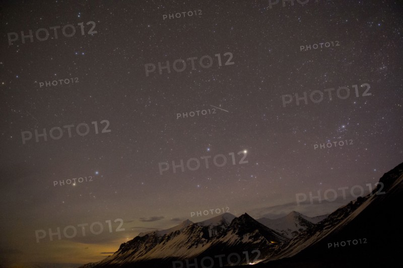 Starry sky over arctic landscape