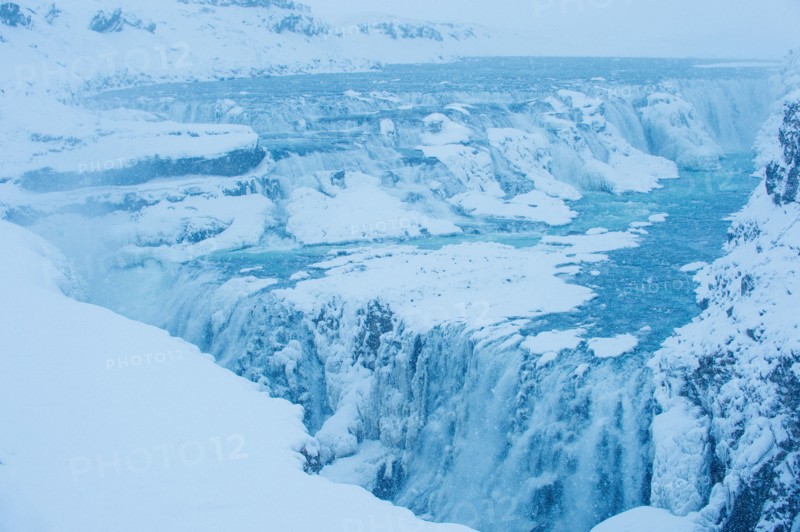 Snowy cliffs and waterfall
