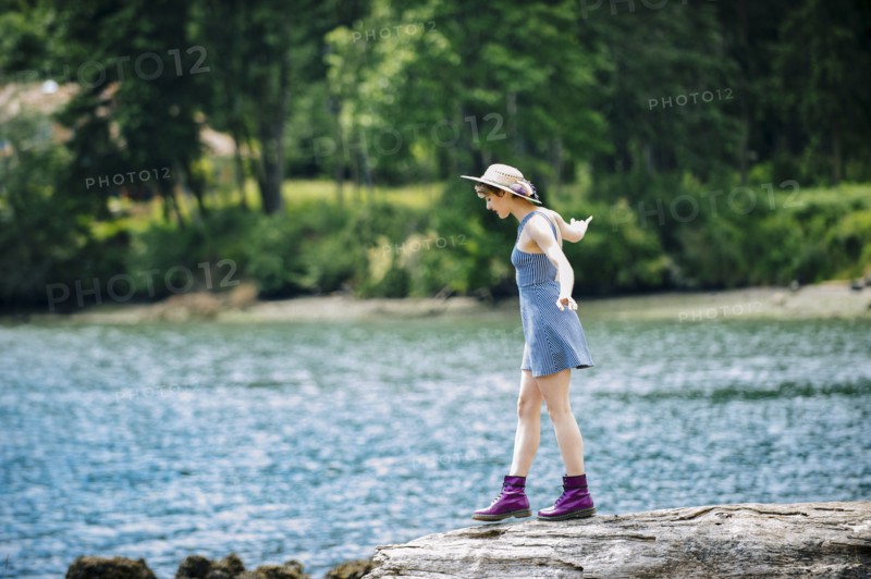 Caucasian woman walking on rock near river
