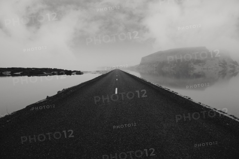 Paved road over still water