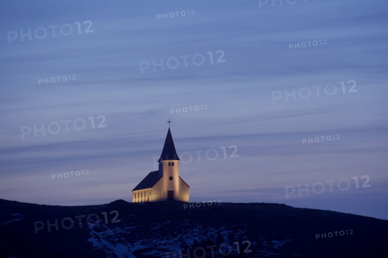 White church illuminated in remote landscape