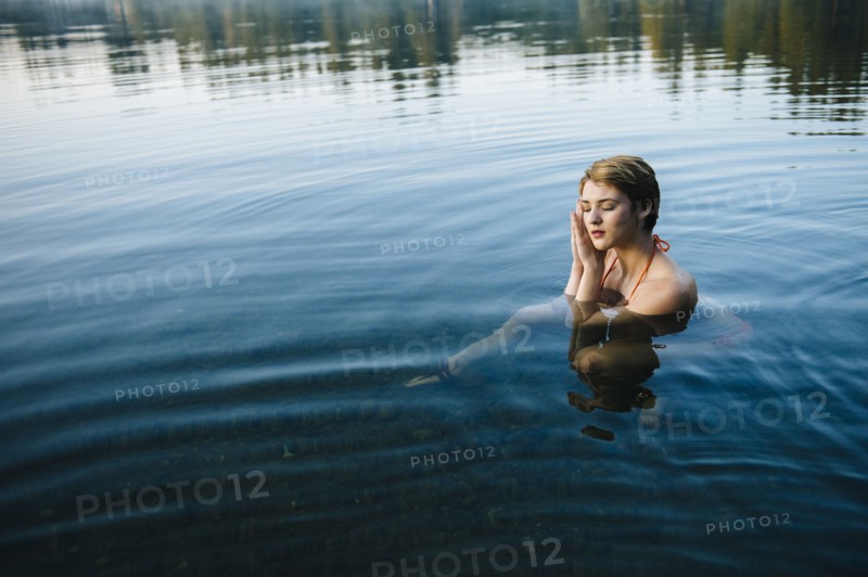 Caucasian woman sleeping in still lake