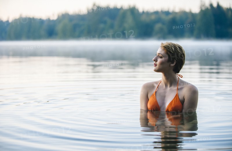 Caucasian woman swimming in still lake