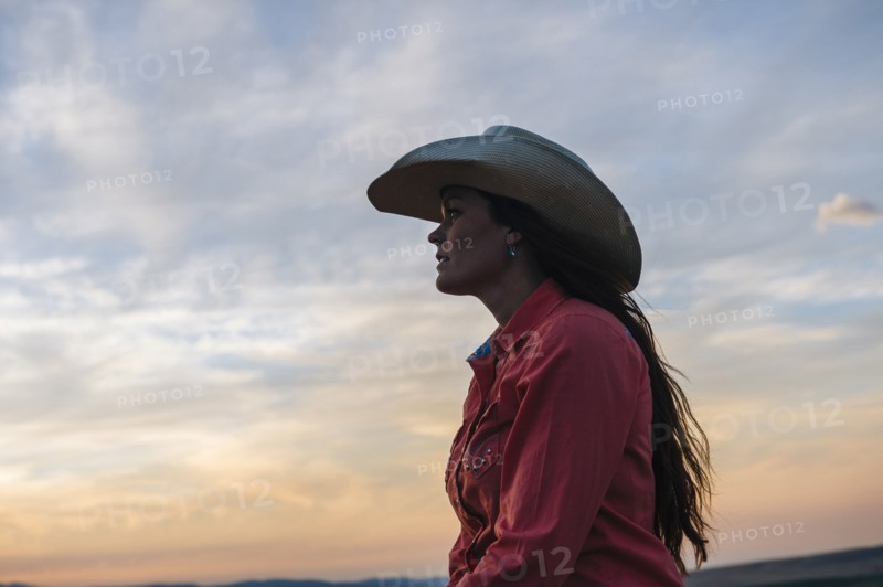 Caucasian woman under sunset sky