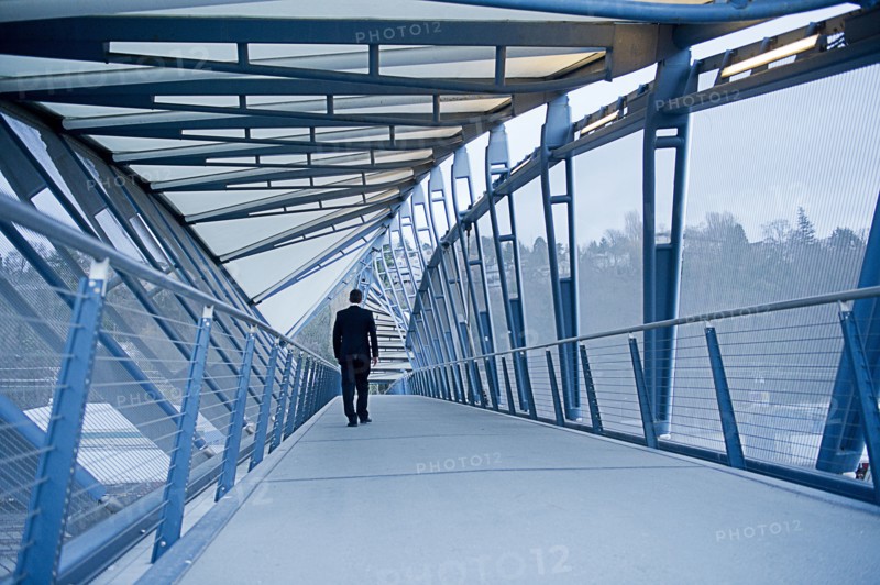 Caucasian businessman walking on sky bridge