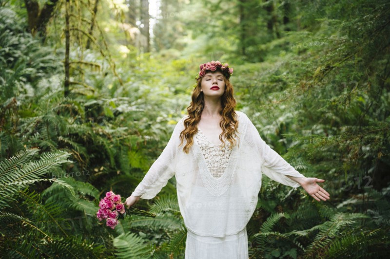 Caucasian woman wearing flower crown in forest