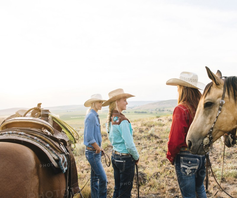Cowgirls with horses on ranch
