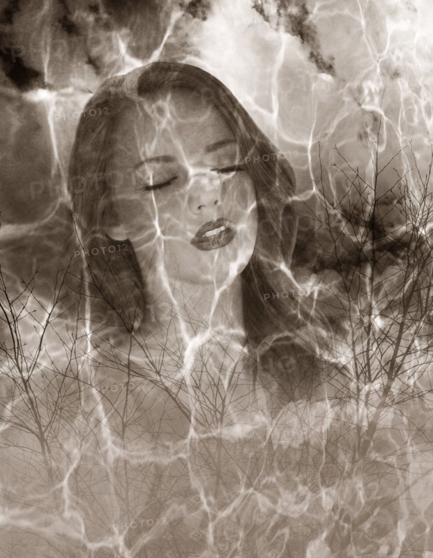 Multiple exposure of Caucasian woman and barren trees