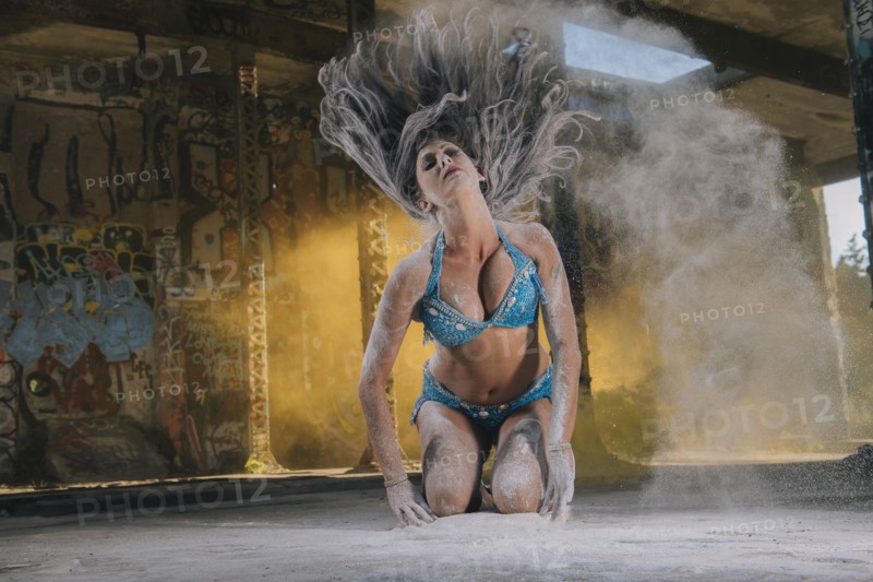 Belly dancer tossing hair with powder