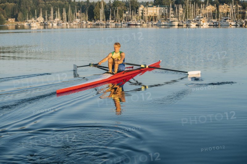 Caucasian man rowing on lake