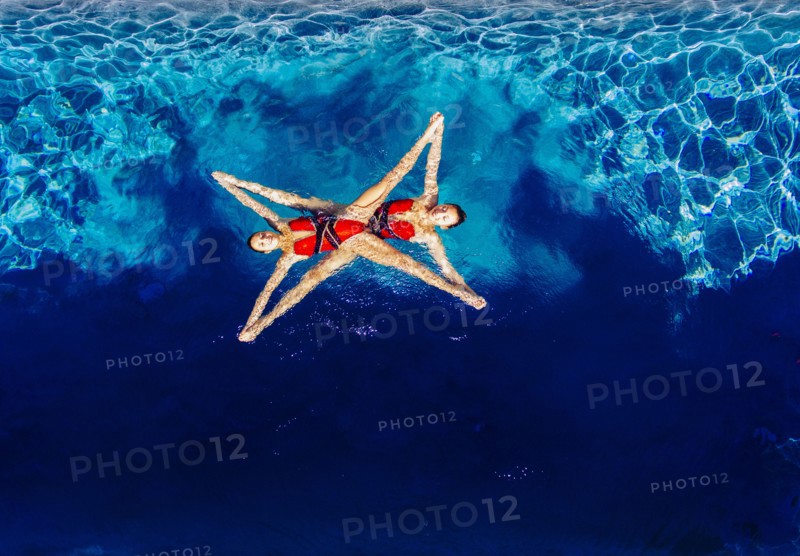 Aerial view of Caucasian synchronized swimmers