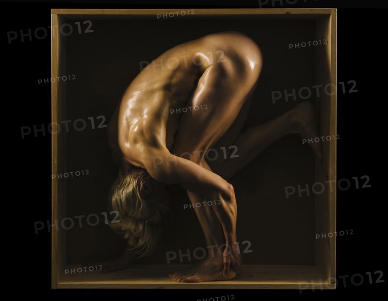 Muscular Caucasian woman bending in box