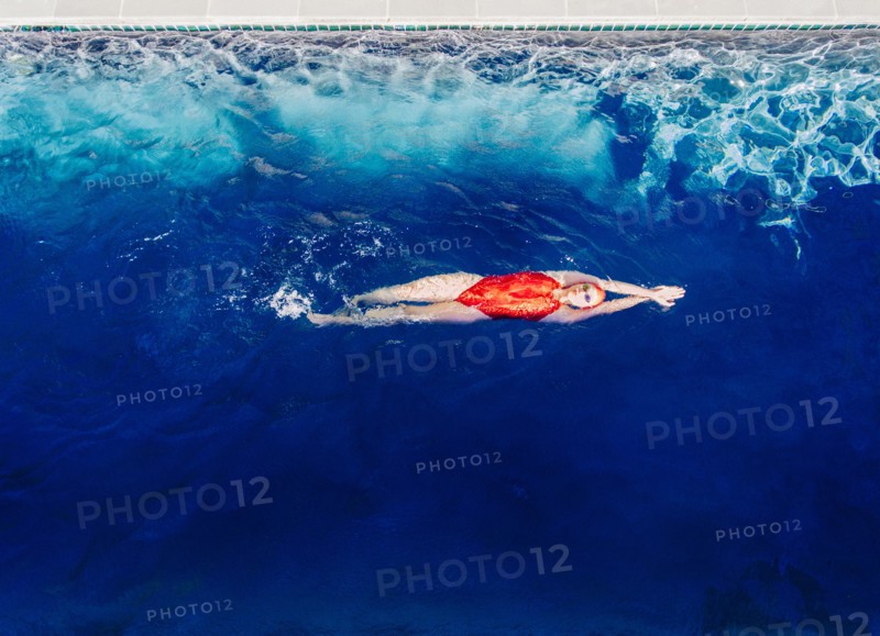 Caucasian woman swimming in swimming pool
