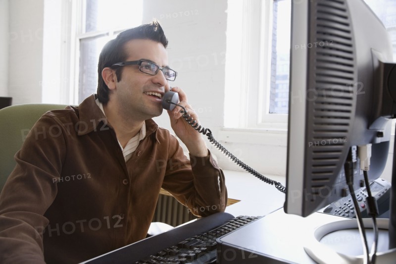 Hispanic businessman talking on telephone