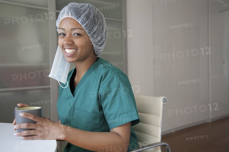 Smiling surgeon drinking coffee