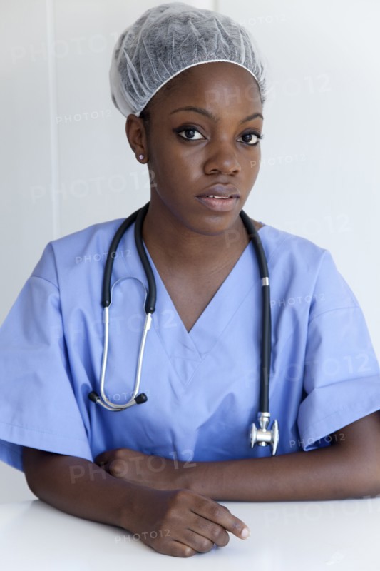 Black doctor in scrubs and surgical cap