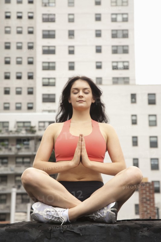 Woman practicing yoga on rooftop