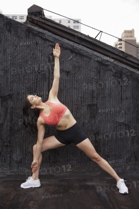 Woman practicing yoga on rooftop