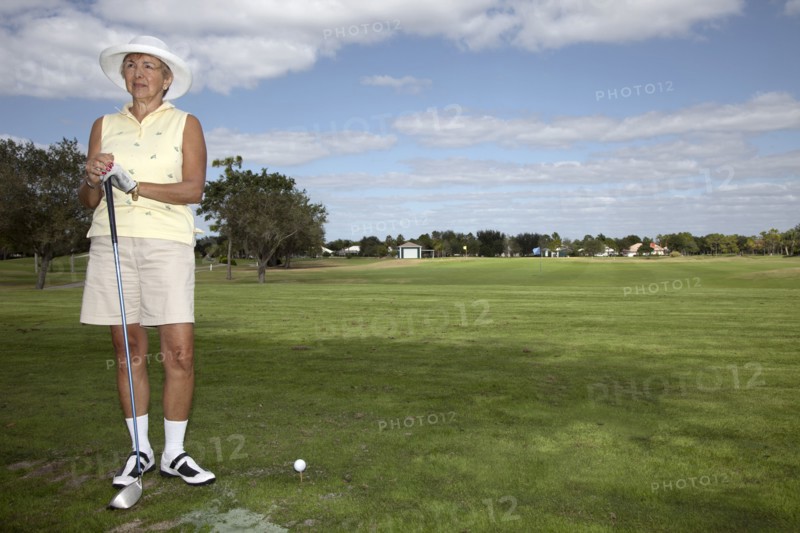 Senior Caucasian woman playing golf