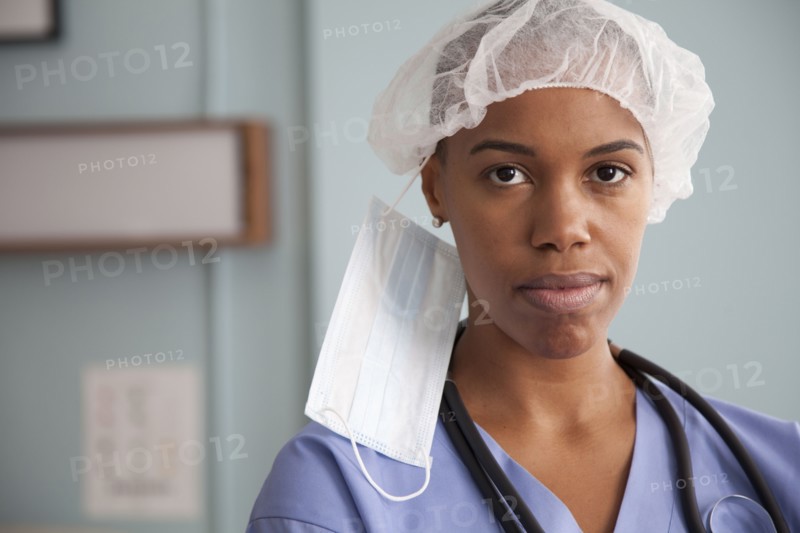 Black surgeon in surgical cap and mask
