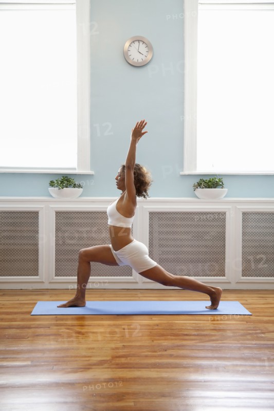 Mixed race woman practicing yoga