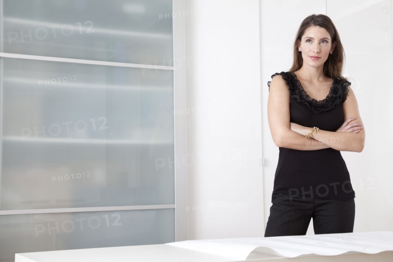 Caucasian architect standing with blueprints