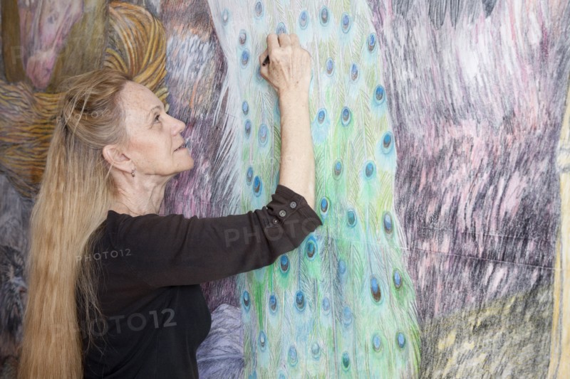 Caucasian woman drawing mural on wall