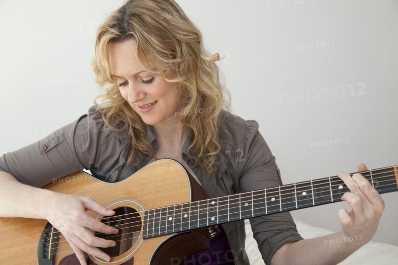Caucasian woman playing guitar