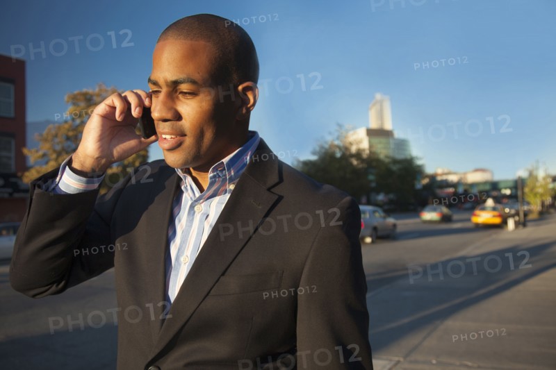 Black businessman talking on cell phone