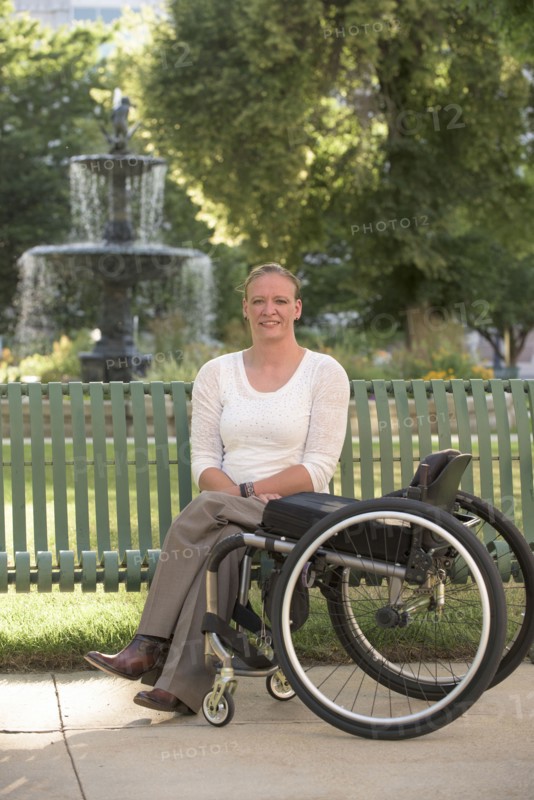 Disabled woman with wheelchair sitting on bench