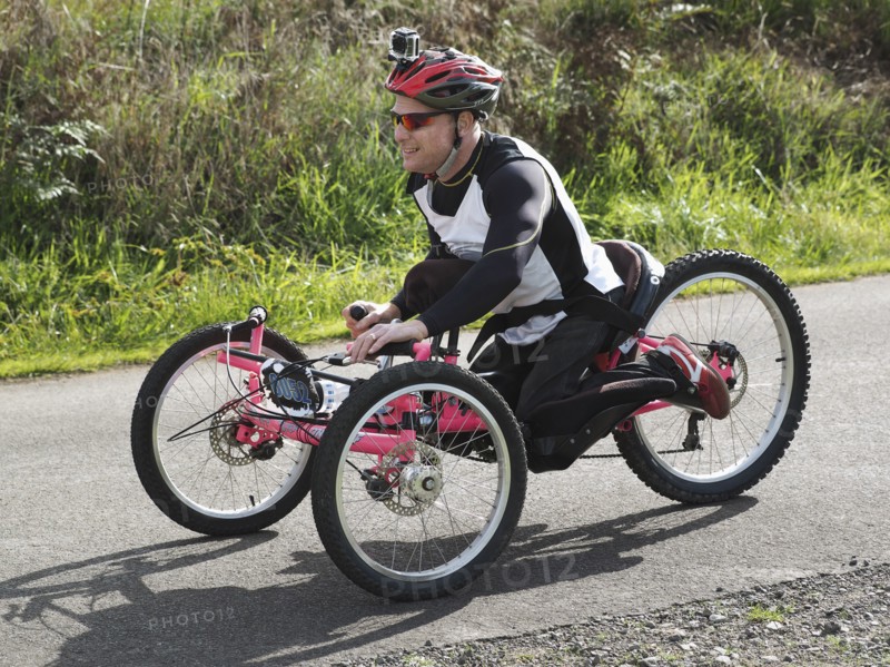 Man riding modified bicycles on rural road