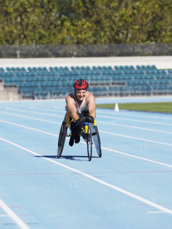 Man racing in wheelchair on track