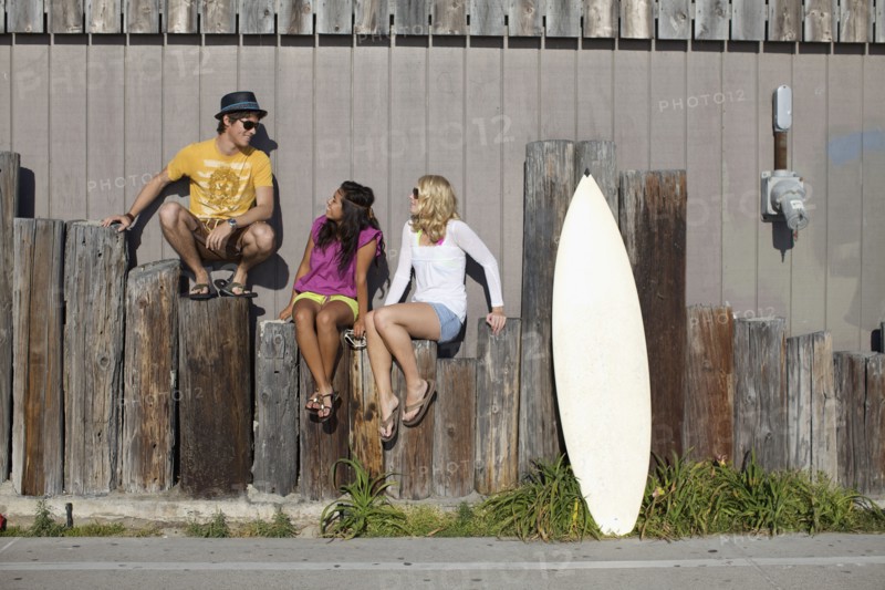 Friends sitting on posts