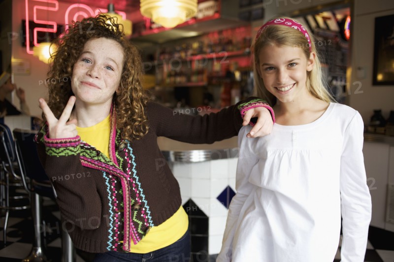 Playful Caucasian girls in cafe