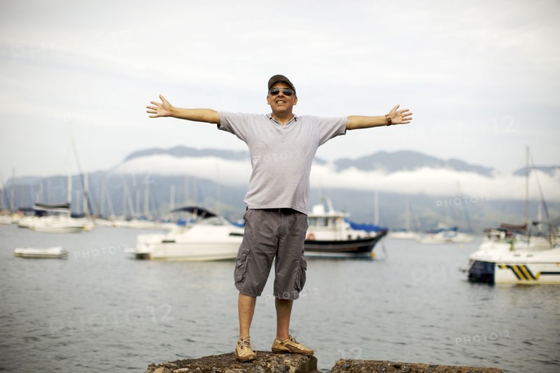 Hispanic man standing at waterfront