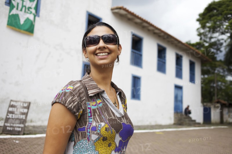 Smiling mixed race woman wearing sunglasses
