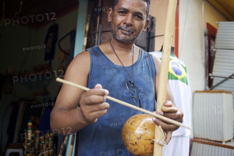 Mixed race man standing with musical instrument