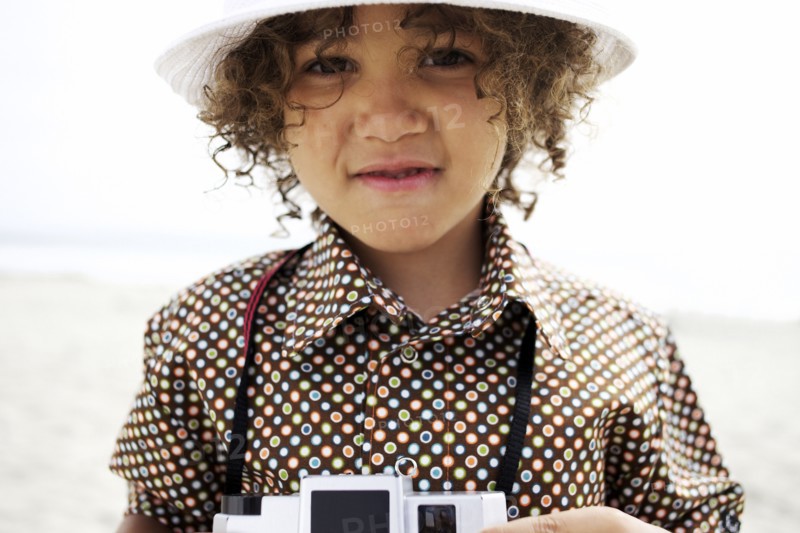 Mixed race boy using old-fashioned camera
